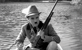 This is eerie, Charlie Chaplin playing Adenoid Hynkel, wearing a traditional Bavarian Costume and going duck hunting.