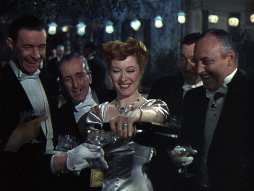 Greer Garson pours the bubbly in Blossoms in the Dust (1941).