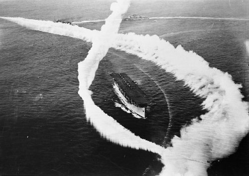 1927 - the USS Langley (CV-1) is practicing maneuvers with a smokescreen. Named after American astronomer, physicist, inventor, and aviation pioneer Samuel Langley, it was the US Navy’s first aircraft carrier. 
Photo from the J.M.F. Haase collection.