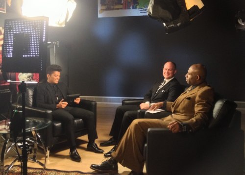 Rich Eisen and Deion Sanders interviewing Bruno Mars.