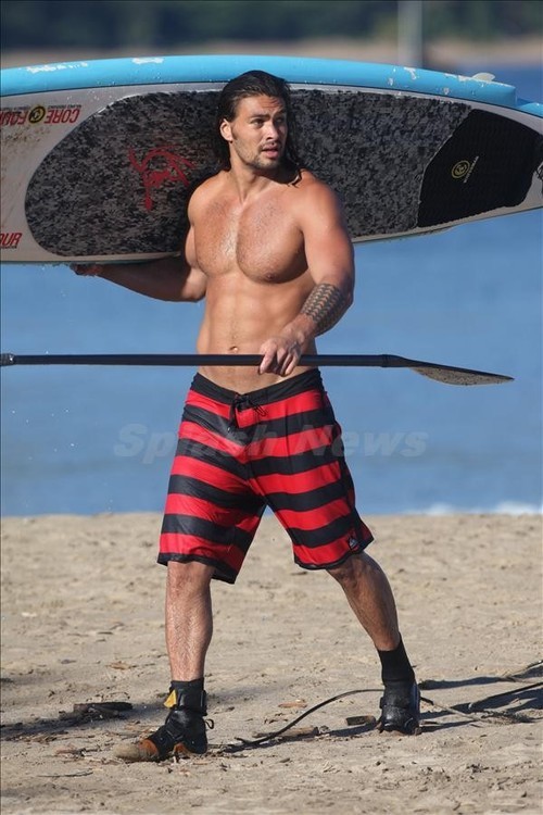 The Gemini with shirtless athletic body on the beach
