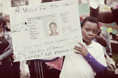 VOICE &#8212; A Cleveland boy holds a sign in memory of Trayvon Martin during a march at downtown&#8217;s Public Square on March 23, 2012. More than 150 people &#8212; many wearing hoodies &#8212; gathered for the march from Public Square to the Cuyahoga County Justice Center. Photo by Brandon Blackwell @CapturedCLE
