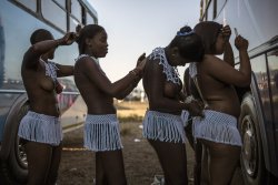     Zulu women at the reed dance. Via The Guardian.      Girls prepare each other for the ceremony.  
