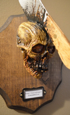 horroroftruant:   This Zombie Trophy Head Wall Mount Taxidermy Sculpture is a resin casting from the original sculpture by Artist Eugene Kaik and is hand painted with acrylic paint. Added to the sculpture is the stained plaque with a label that reads