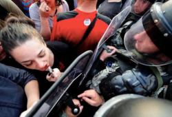 allabitfuzzy:  sixpenceee:A woman protestor in Macedonia uses a riot shield as a mirror to reapply her lipstick. There’s something so powerful about this image.  Not quite a flower in a rifle, but a similar vibe.