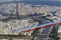 Contrails of colour (the French Aerial Display Team roars past the Eiffel Tower during celebrations on Bastille Day)
