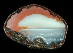 sixpenceee:  The cross-section of the above agate looks like a cross-section of an ocean.  