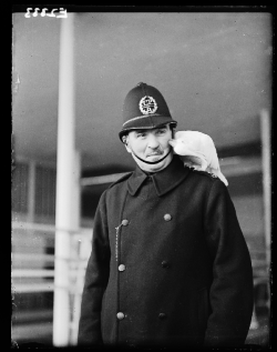 weirdvintage:  Policeman with a cockatoo on his shoulder.  The lemon crested cockatoo was a competitor at the Crystal Palace Cage Bird Show, 1935.  Photo by James Malindine for the Daily Herald (via National Media Museum UK/Daily Herald Archive) 