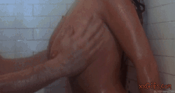 Brunette girl enjoys boobs massage in shower  