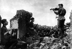 bag-of-dirt:  Soviet soldiers play a nocturne for their comrades amidst the ruins of battle. Novoshahtinsk, Rostov Oblast, Russia, Soviet Union. Autumn 1942. Photograph by Yakov Khalip.
