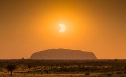 I’m waiting for a sign (partial solar eclipse over Uluru, Australia)