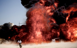 picaet:An Iranian man who was fixing explosives wires run away after setting ablaze 50 tons of drugs seized in recent months in eastern Tehran to mark the International Day Against Drug Abuse and Illicit Trafficking.Picture: Behrouz Mehri