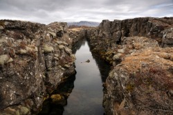  Iceland sits atop the Mid-Atlantic Ridge, the fault line where two of the Earth’s tectonic plates are slowly drifting apart; as a result, Iceland is getting wider at a rate of roughly 1cm per year. On both sides of the ridge, earthquakes and volcanoes