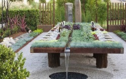 starkmartell: sixpenceee:  Irrigated garden dining table. From here  This is absolutely gorgeous.  
