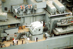 poirtland:A 5″/38 turret on USS New Jersey. Tomahawk missile launchers located just above the turret.