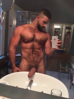 stratisxx:  Big Greek cock for you. You can see in the mirror reflection that this hairy Greek stud already has a boy lined up to ride that fat hairy dick.