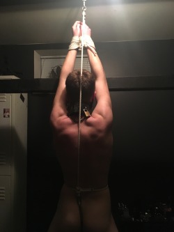 seabondagesadist:  Ass hook predicament bondage. The boys hands were tied above his head with the end of the rope fed through a pulley at the top of the frame. The end of the rope was attached to the ring of the ass hook. The rope was pulled tight forcing