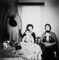 sixpenceee:  As the Cooper’s move into their new home in Texas, they take a photograph of the family sitting together, but as the photo is taken, a body falls from the ceiling. The OP said he wasn’t sure if it was real, but he thought it was real