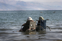 killing-the-prophet:Elderly Palestinian women sit in wheelchairs as they enjoy the waters of the northern part of the Dead Sea, in the West Bank, on October 2, 2008.Menahem Kahana