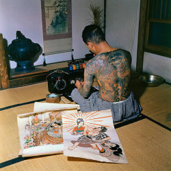 s-h-o-w-a:Japanese tattoo artist, Tokumitsu Uchida proudly displaying tattoo markings made by his father, Goro Uchida, Japan, 1955