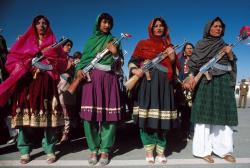 warkadang:  Abbas &gt; Communist Afghanistan AFGHANISTAN. Kabul. May 27, 1986. Armed women in traditional clothes celebrate the anniversary of the Coup d’Etat of 1978 when Communists seized power. They hold Russian-made Kalashnikov submachine guns.
