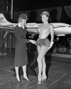 SAS stewardess Birgitta Lindman examines a showgirl’s costume - photo by Harry Todd, January 12, 1959. .