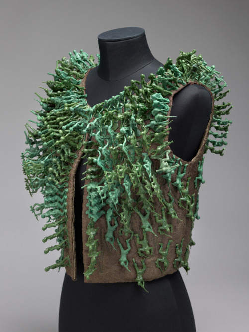 blondebrainpower:“Combat Vest,” by Sheila Perez. Molded plastic figures on quilted plain weave supplemental warp and weft patterning, Center Back Length: 16 ¼ inches. Length: 18 inches, Circumference (Bust): 36 ½ inches. Promised gift of The Julie