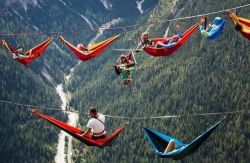sixpenceee:  At the International Highline Meeting in the Italian Alps, the event featured tightrope walkers moving from mountain to mountain and sleeping in hammocks suspended thousands of feet in the air.