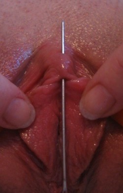 pussymodsgaloreBDSM pain games. Top picture: a needle is thrust vertically through her clit hood (and clit?). Lower picture: Safety pins in her pierced inner labia are used to spread her pussy. Two hypodermic needles are vertically through her clit. PMG