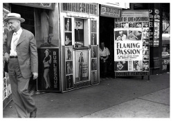 Vintage photo dated from July of ‘41, features a man passing the entrance of an unidentified Burlesque theatre; located somewhere on S. State Street in Chicago.. Photographed by - John Vachon