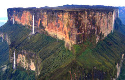 douces-levres:  sixpenceee:  Mount Roraima, South America: This tabletop mountain is one of the oldest mountains on Earth, dating back two billion years when the land was lifted high above the ground by tectonic activity. The sides of the mountain are