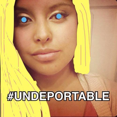 Selfie of a young woman with drawn-on blonde hair and blue eyes and the caption 