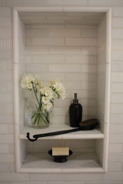 sweetestesthome:  shower niche with shelf. Nicely played. Like the small space, then the tall space. I do not think I will ever have a vase of flowers there. More likely? Shampoo. Wonder about making the back a mirror…
