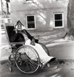 Diane Arbus - Masked Woman in a Wheelchair, PA, 1970.