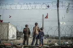troposphera:  Idomeni, Greece Three boys in the Idomeni refugee camp wait for the border between Greece and Macedonia to reopen. Thousands of refugees became trapped in the camp when the border was closed last March. Photograph: Pablo Tosco/Oxfam 