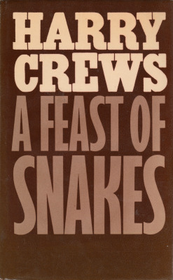 A Feast Of Snakes, by Harry Crews (Secker &amp; Warburg, 1977). From a charity shop in Canterbury.She felt the snake between her breasts, felt him there, and loved him there, coiled, the deep tumescent S held rigid, ready to strike. She loved the way