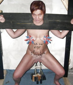 I think it says &ldquo;I am a fuck slave&rdquo;. BDSM. No piercings visible, just temporary clips, A good bit of weight on there, not much progress yet, but keep up the good work, over time her flaps will be extended considerably.
