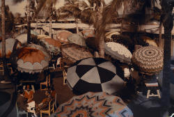 natgeofound:  Club members on the ocean front are shaded by decorative parasols, 1930.Photograph by Clifton R. Adams, National Geographic