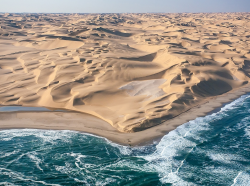 boss-hoody:  sixpenceee:  This is where the Namib desert meets the Atlantic ocean.  Man, I’d be super pissed if I was stranded in the desert, thirsty as hell, and then the first water I came across in days turned out to be salty, undrinkable ocean water