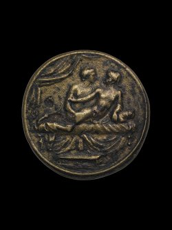 ancientpeoples:  Spintria 1st Century A.D. Roman Empire Copper alloy spintria. Male lovers on bed; the eromenos (younger ‘beloved’, passive) is looking back at the erastes (older, active lover) and reaches back to hold his partner’s upper arm.On