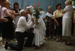 unrar:  A woman in veil and gown kisses her husband on their 50th anniversary, Ukraine, Ed Kashi. 