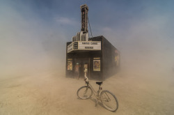 reblololo:  Smithsonian Magazine’s 2013 Photo Contest - In Focus - The Atlantic Finalist, Americana category. Dust swirls around citizens of Black Rock City as they peek into the “Black Rock Bijou Theatre,” an art installation at the 2013 Burning