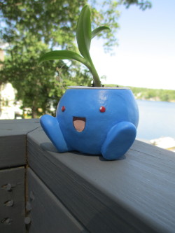 tallymark2:  As long as I’m going through my camera, here’s a picture from last year of an oddish planter. :) Hand-cast in blue resin from a sculpture I made, with a hand-painted face, sealed with a matte varnish and UV-protective spray. He’s designed
