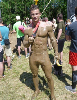 muscletits:  Showing off his medal, and banana. The one in his hand. A tease in the highest order.  How would you get the mud off?  Fire hose water, scraping steel wool?  Tie him down and begin…   hot as fuck