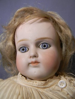 hazedolly: A pretty, spooky antique bisque dolly with piercing blue glass eyes. Source: eBay.com 