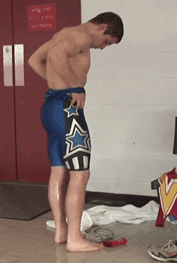 wrestlerinsinglet:  Cute wrestler pulling down his singlet showing his big bubble butt gif