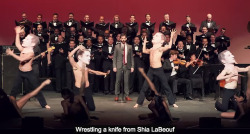 fenchurchdent:  schmoyoho:  In which a children’s choir, grown-up choir, orchestra, dancing paper-mache-head Shia LaBeoufs, and aerialists perform a song about Shia LaBeouf’s gruesome cannibalistic nature TO SHIA LABEOUF. Thank goodness for the internet