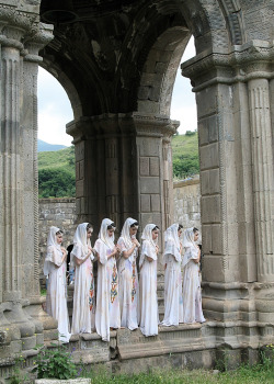 Armenian women in traditional dress prepare for an Armenian Apostolic Orthodox ceremony at Tatev Monastery, Armenia