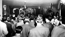 Winnie Garrett (aka. “The Flaming Redhead” ) performs to a standing-room only crowd at ‘Club HA-HA’ on NYC’s famed 52nd Street.. Winnie performed consecutive 14-week runs there, from 1948 thru 1954..