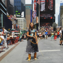 zeppelin-rules:   Naelyn Pike, a 16-year-old member of the Chiricahua Apache tribe, demonstrated in Times Square on Friday against a land swap between the federal government and a copper company that could affect land the protestors hold sacred. NY Times